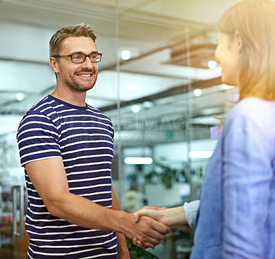 Buy stock photo Man, woman and handshake with smile at startup for welcome, introduction or onboarding with respect. Business people, shaking hands and happy for b2b deal, teamwork or thanks at creative media agency