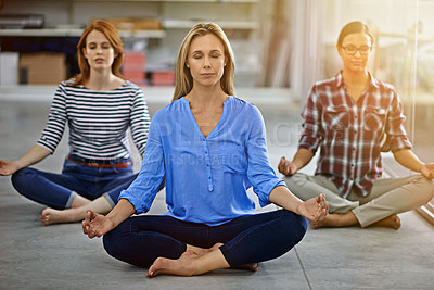 Buy stock photo Full length shot of three businesswomen meditating in the office
