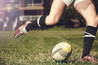 Buy stock photo Rugby, man and feet kick sports ball outdoor on a pitch for action, goal or score. Male athlete person playing in sport competition, game or start training for fitness, workout or exercise on grass