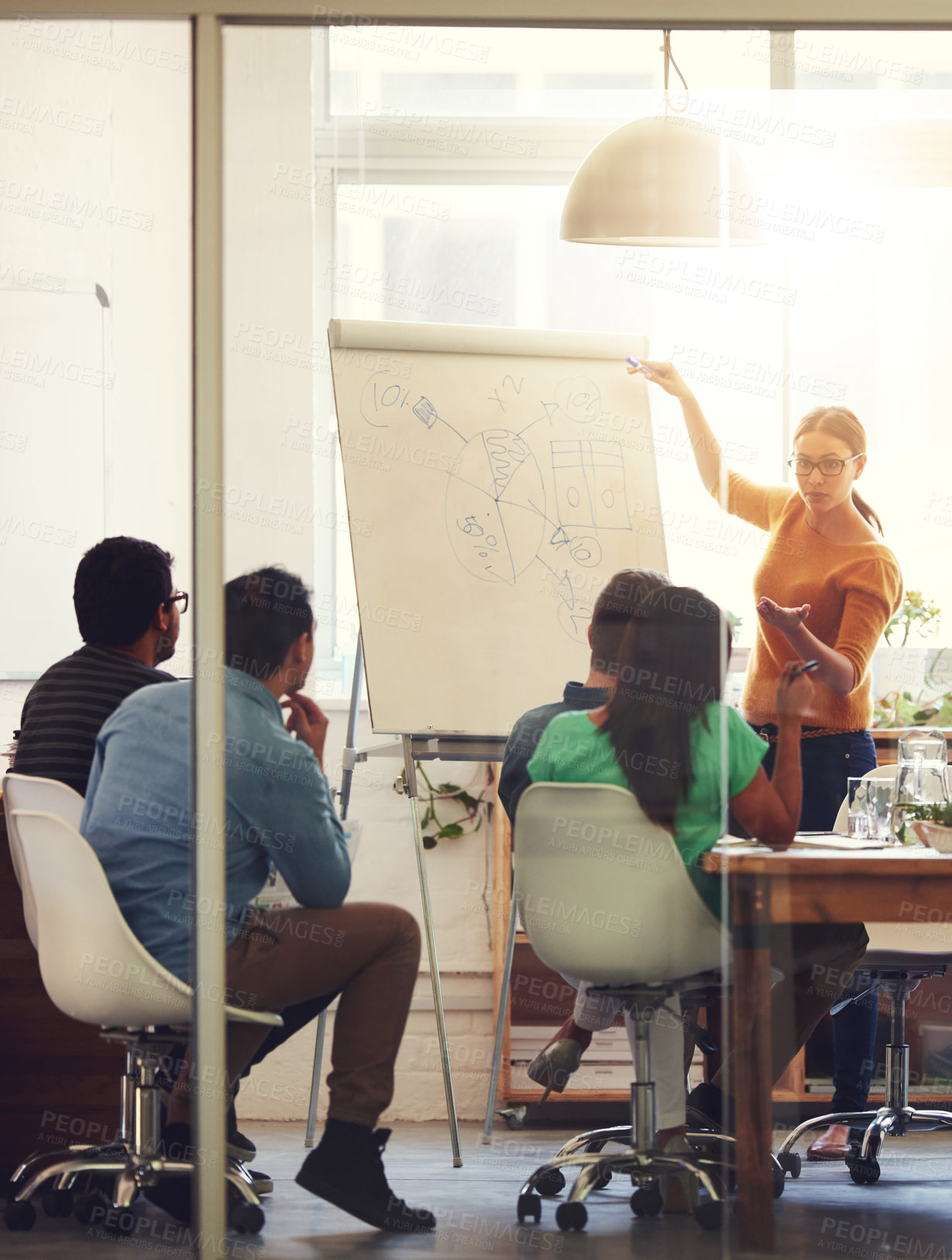 Buy stock photo Shot of a group of coworkers in a boardroom meeting