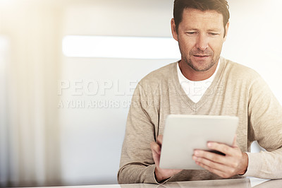 Buy stock photo Social networking, mature and man with tablet and at table at his home. Blog or internet connectivity, technology and mockup space with male person reading  an email or report at desk his house.