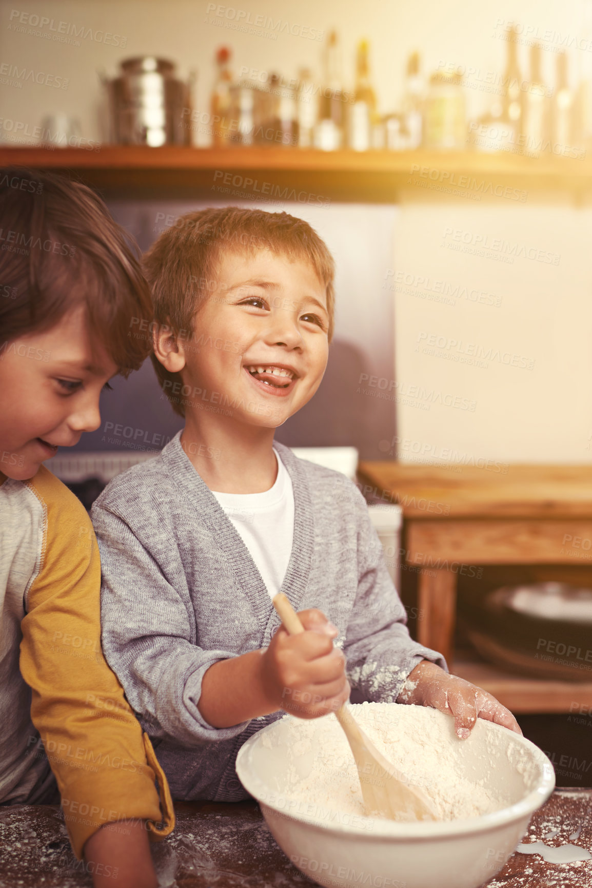 Buy stock photo Happy, kitchen and children baking in home with ingredients, flour and mixing bowl for cookie dough. Utensils, siblings and learning for holiday, pastry recipe and dessert cake by lens flare.