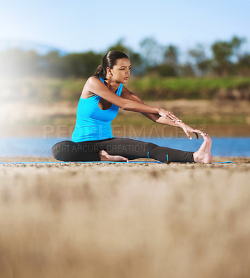 Buy stock photo Shot of a young woman exercising outdoors