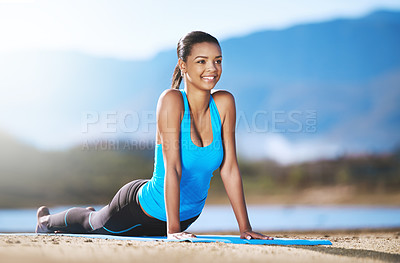 Buy stock photo Shot of a young woman practising yoga outdoors