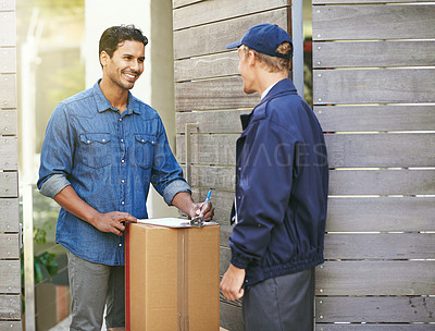 Buy stock photo Cropped shot of a young man receiving a package at home