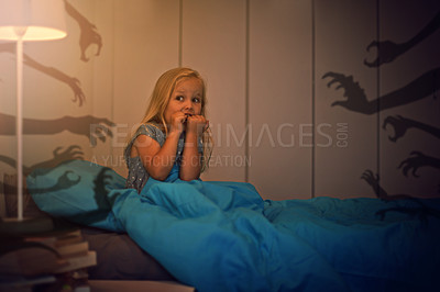 Buy stock photo Shot of a frightened little girl being kept awake by scary shadows