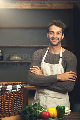 Buy stock photo Chef, smile and portrait of man with arms crossed in rustic kitchen with vegetables for nutrition and vegan ingredients. Confidence, male cook and happy person from Norway ready to start cooking.