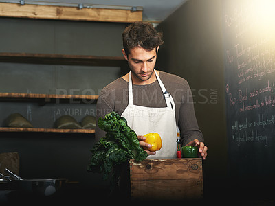 Buy stock photo Man, market and owner with vegetables or groceries in a  bag for cooking or chef in the kitchen and at a supermarket. Male, shopkeeper and sorting healthy food dinner or packaging box of ingredients 