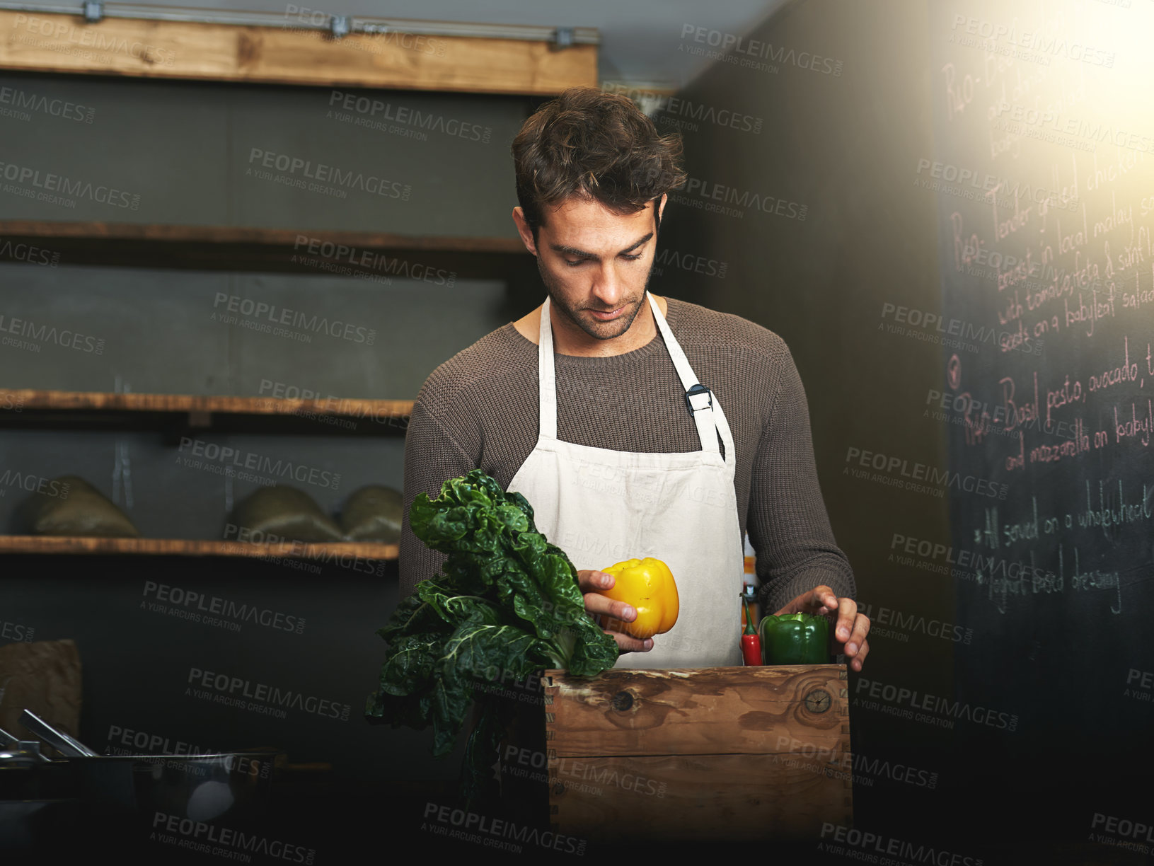 Buy stock photo Man, market and owner with vegetables or groceries in a  bag for cooking or chef in the kitchen and at a supermarket. Male, shopkeeper and sorting healthy food dinner or packaging box of ingredients 