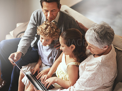Buy stock photo Grandparents, laptop or fun kids learning how to type or playing online game in family home together. Education, child development or children siblings on computer with grandmother or grandfather