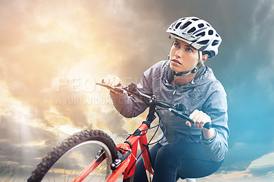 Buy stock photo Shot of a female mountain biker out for an early morning ride