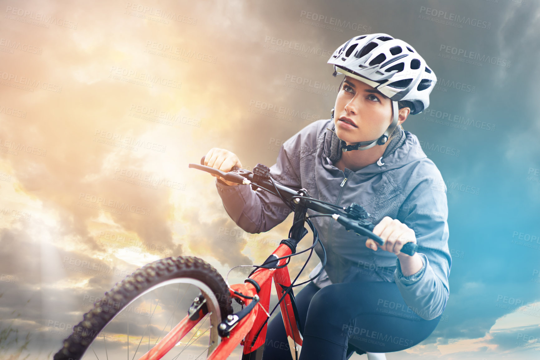 Buy stock photo Shot of a female mountain biker out for an early morning ride