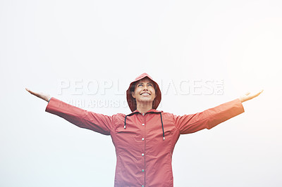 Buy stock photo Happy woman, rain jacket and freedom with hood for weather, cloudy sky or winter season in outdoor storm. Female person with smile in red waterproof raincoat for overcast, fog or snow on mockup space