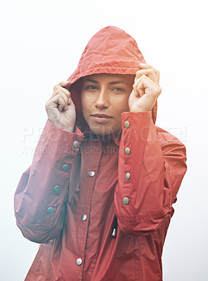 Buy stock photo Woman, portrait and rain jacket with hood for weather, cloudy sky or winter season in outdoor storm. Face of female person or young model with red waterproof raincoat for rainy overcast, fog or snow