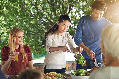 Buy stock photo Food, salad and help with family at lunch in nature for health, bonding and celebration. Vacation, barbecue and event with parents and children eating together for garden, generations and wellness
