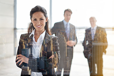 Buy stock photo Cropped portrait of a businesswoman standing a lobby with her colleagues in the background