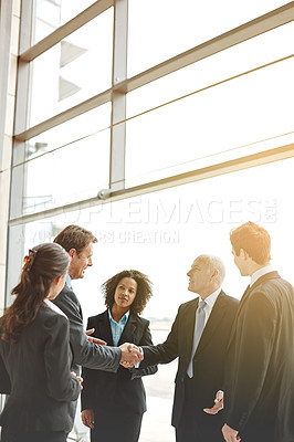 Buy stock photo Business, professional and together with handshake about project in the company for a partnership deal. Group, corporate and people for contract in a lobby for negotiation for b2b support in office
