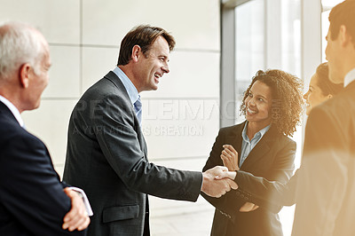 Buy stock photo Group, professional and negotiation with handshake for agreement with conversation at the office. Business, people and welcome partner in the lobby for a discussion about contract in the company.