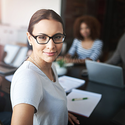 Buy stock photo Portrait of a young office worker in a meeting with colleagues in the background