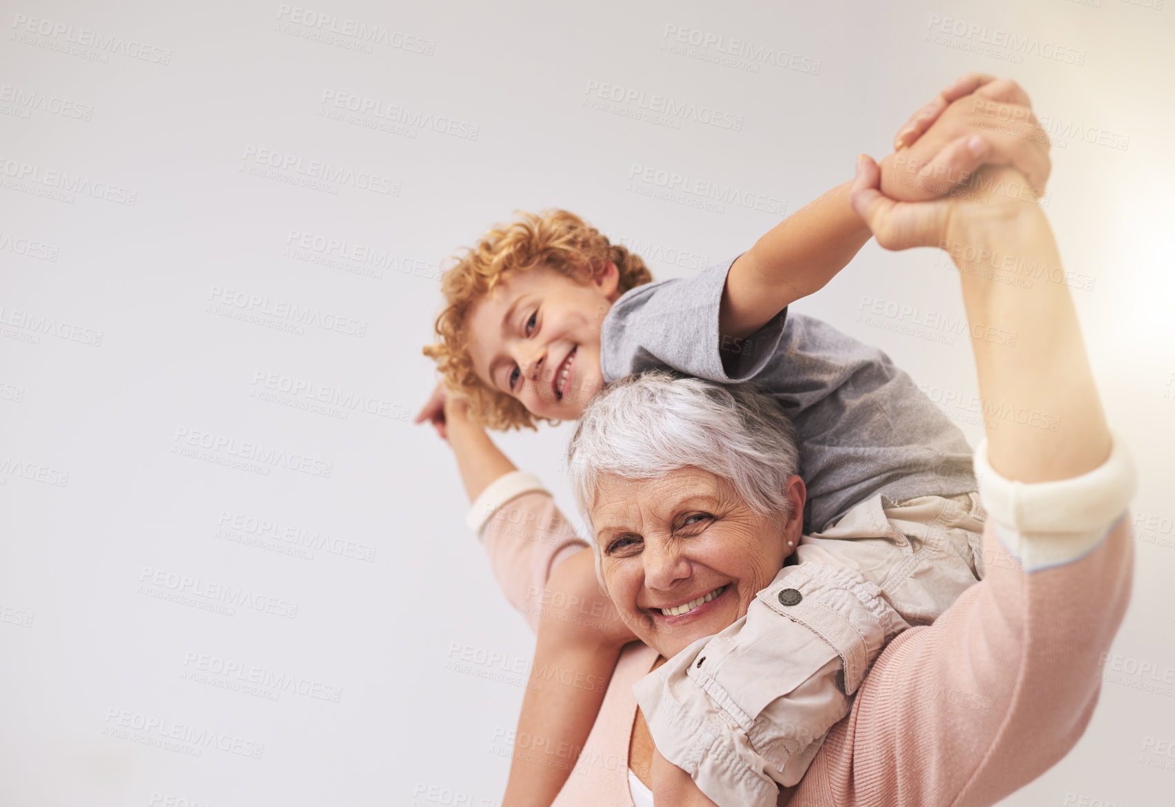 Buy stock photo Shot of a grandmother giving her grandson a piggyback ride
