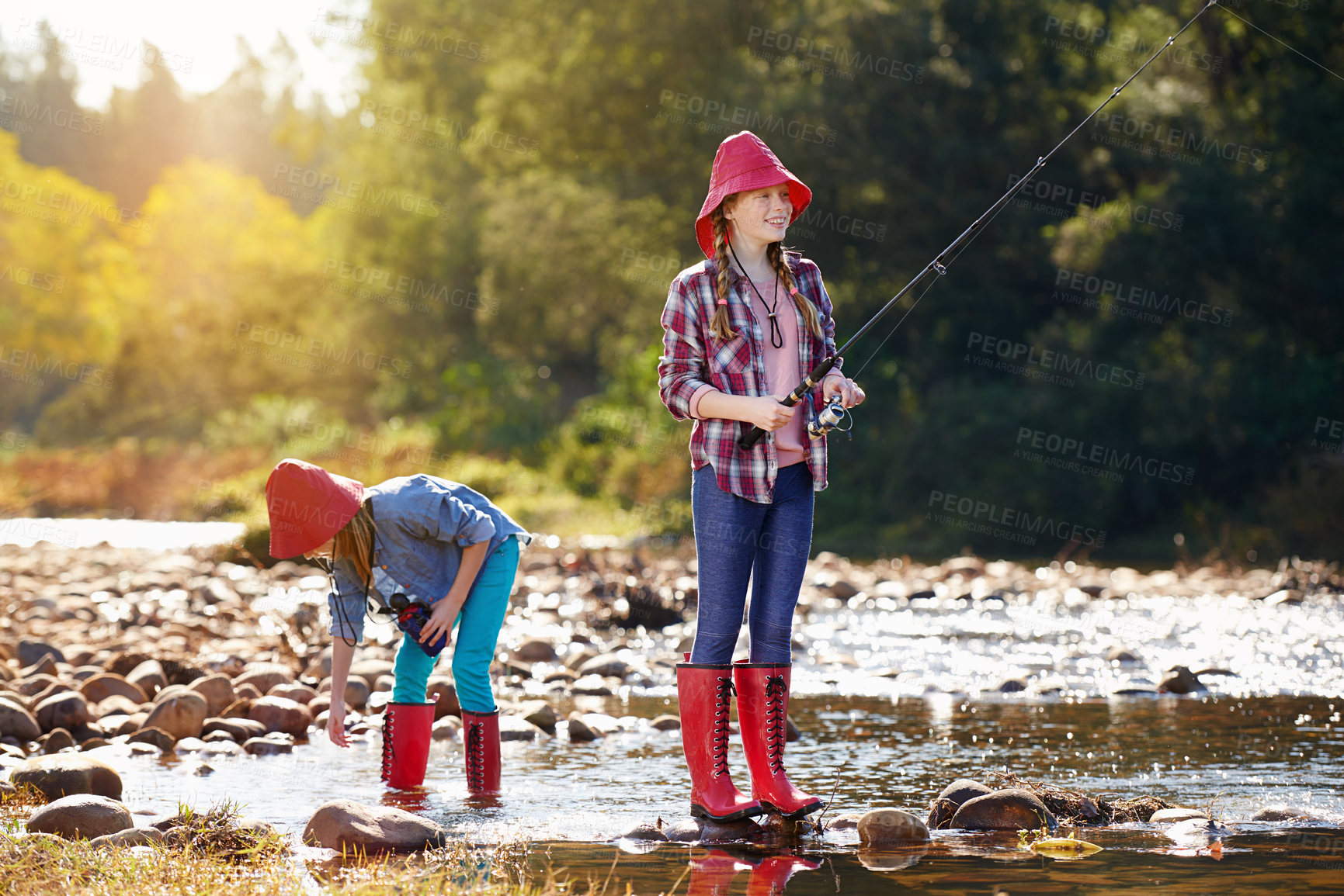 Buy stock photo Countryside, children and fishing rod in river on holiday break, vacation or adventure as hobby. Sunshine, girls or siblings and activity to catch fish in water on weekend trip, outdoor and nature