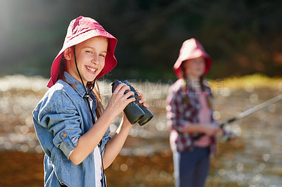 Buy stock photo A young girl holding a pair of binoculars in the outdoors