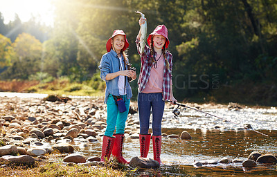 Buy stock photo Countryside, portrait and children with fish in river on holiday break, vacation or adventure as hobby. Sunshine, girls or siblings and fishing rod in water on weekend trip, outdoor and nature