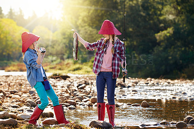 Buy stock photo Countryside, binocular and fish with girls in river on holiday break, vacation or adventure as hobby. Sunshine, happy children or siblings and fishing rod on weekend trip, outdoor and nature to bond