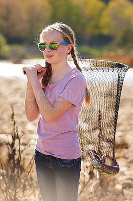 Buy stock photo Fish net, nature and girl child with sunglasses for outdoor activity on weekend camp trip. Fishing, pond and young kid with adventure or learning hobby on summer vacation or holiday by river.