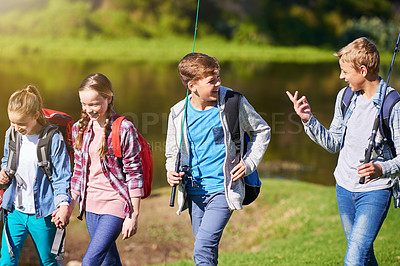 Buy stock photo Walking, nature and children friends camping with backpack for vacation, adventure or holiday. Happy, fishing and group of teenagers by outdoor pond, river or lake water for weekend trip together.