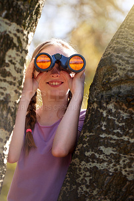 Buy stock photo Tree, girl and binoculars for safari, search and looking for animals on travel holiday. Smile, fun and seek for bird watching or wildlife in nature, happy young child and scenery or view in Kenya