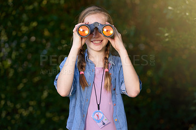 Buy stock photo Shot of a little girl looking through binoculars in the outdoors