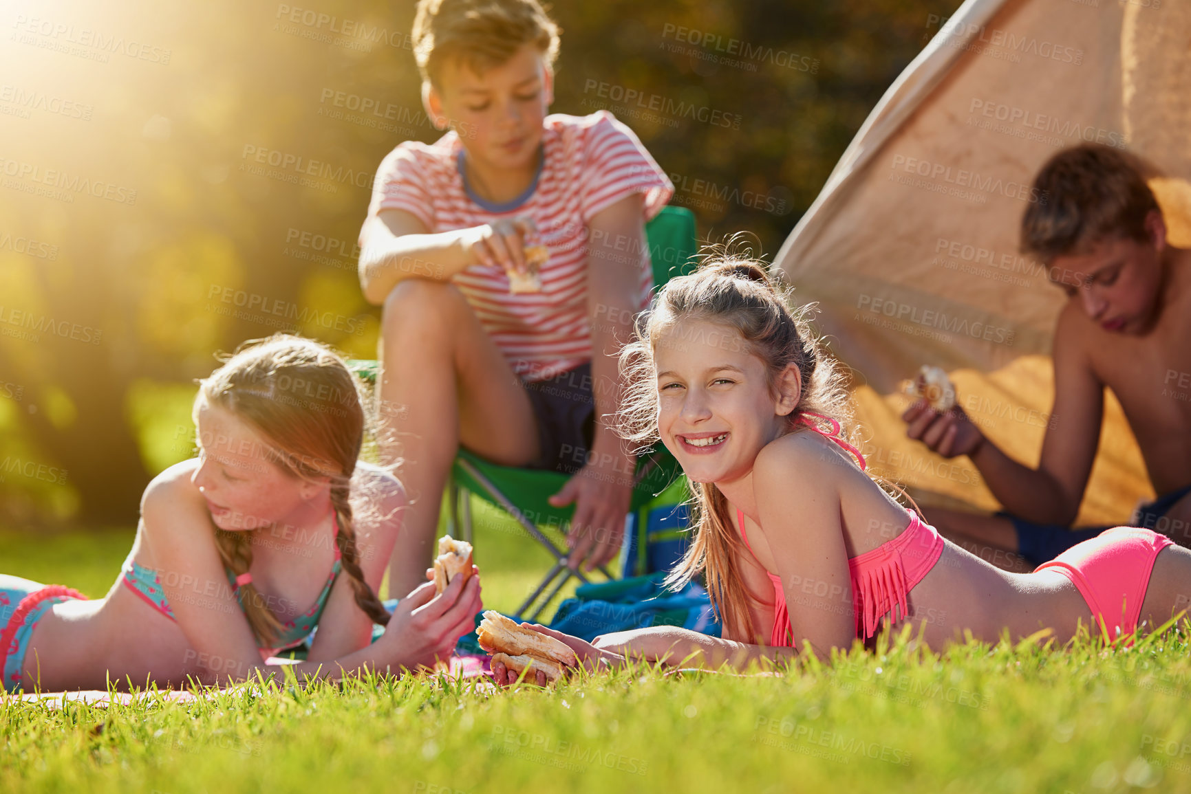 Buy stock photo Portrait, nature and children in tent for camping in forest for vacation, holiday or adventure. Travel, friends and group of teenager friends eating in outdoor field for summer weekend trip together.