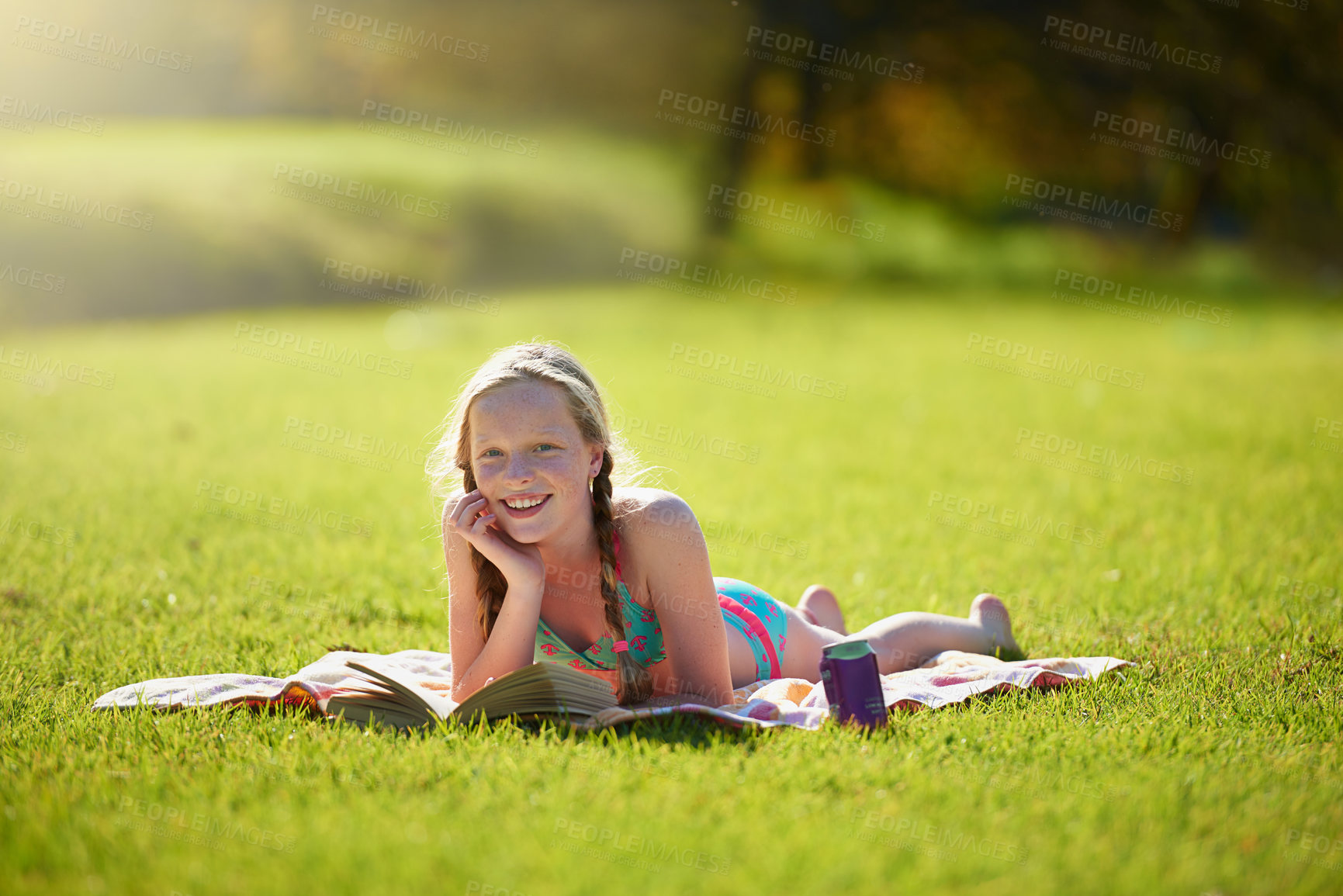 Buy stock photo Portrait, girl or book on grass, reading or imagine by story, freedom or vacation at summer camp. Tween, novel or fiction as lying happy to wonder at idea of daydream, fantasy or sunshine at weekend