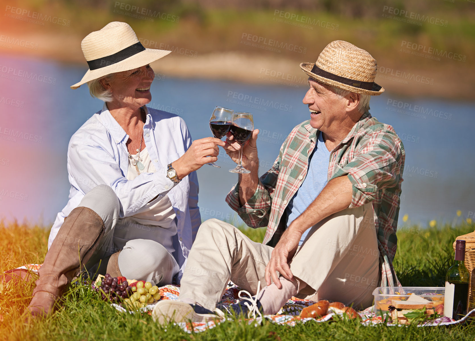 Buy stock photo Shot of a happy senior couple enjoying a picnic  outdoors