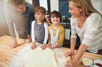 Buy stock photo Learning, happy and family baking food in kitchen together, bonding and smile in home. Pizza, mother and father with kids cooking, teaching and help parents with flour dough for preparation at table