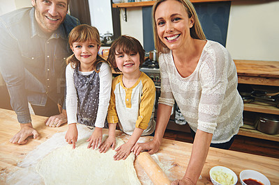 Buy stock photo Portrait, smile and family baking in kitchen together, bonding and happy for learning in home. Face, mother and father with kids cooking pizza, teaching and help parents with flour dough at table