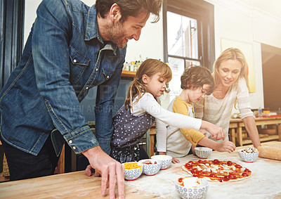 Buy stock photo Cropped shot of a family enjoying pizza at home