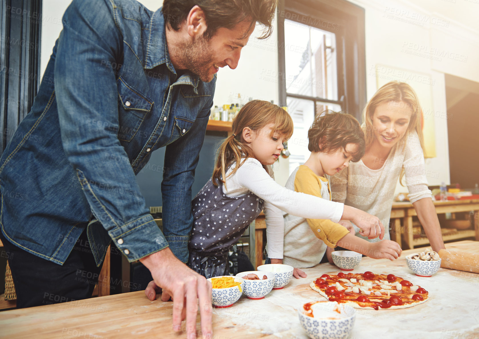 Buy stock photo Cropped shot of a family enjoying pizza at home