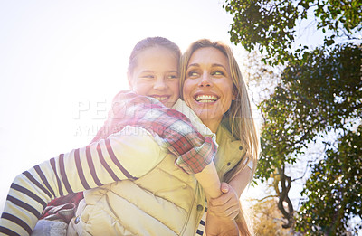 Buy stock photo Hug, piggyback and happy kid, mom or free people enjoy family time, freedom and wellness on bonding walk. Sky, sun flare and youth girl with mother, mama or woman smile for outdoor fun on Mothers Day