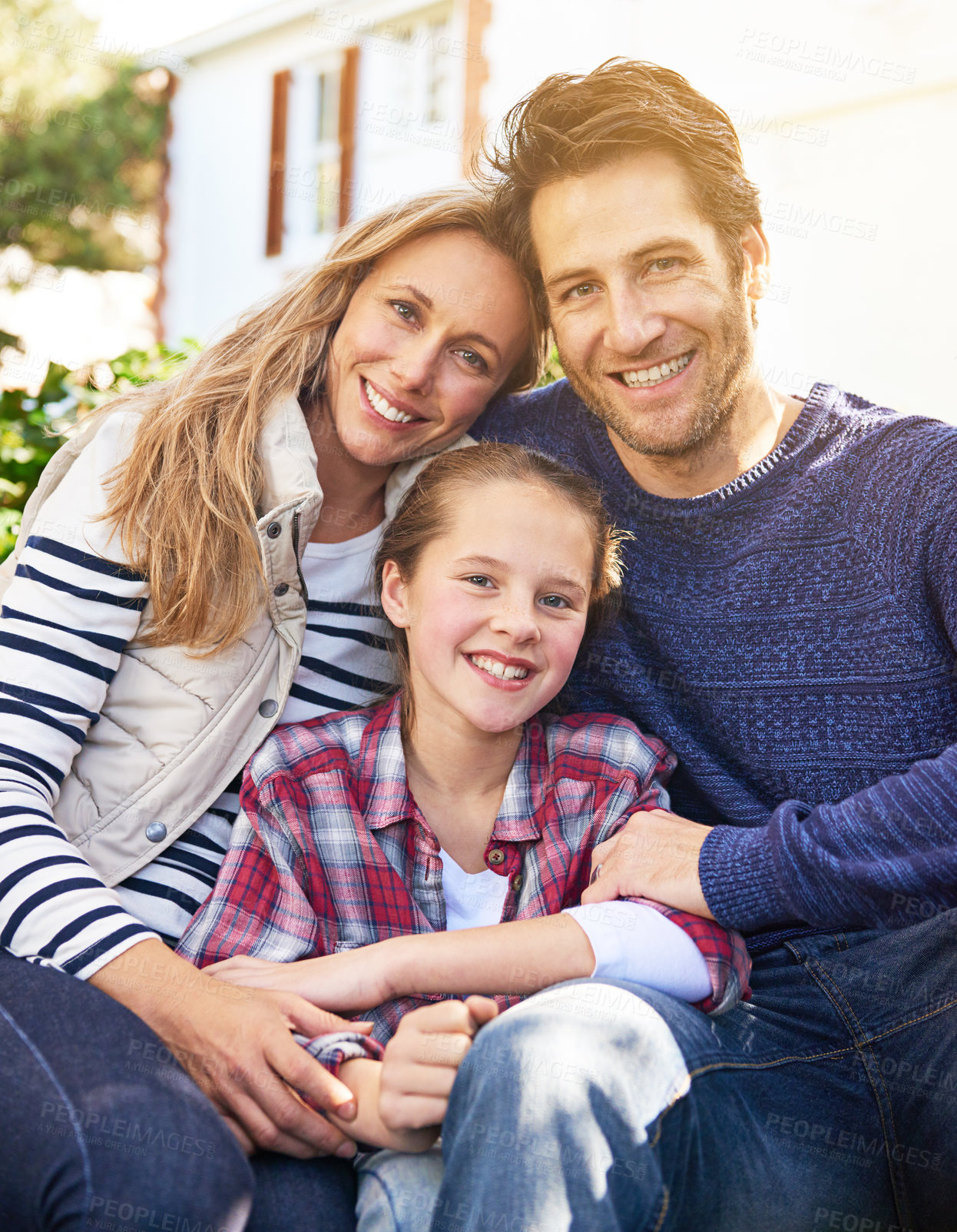 Buy stock photo Backyard hug, family portrait and outdoor parents, child and faces of people bonding, support and quality time together. Love, happy childhood and Canada mother, dad and kid enjoy spring sunshine 