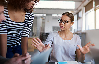 Buy stock photo Shot of a group of coworkers brainstorming during a meeting