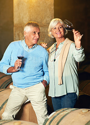 Buy stock photo Mature couple, cellar and glass for wine tasting, retirement and france holiday together. Elderly man, woman and romance with winery date, vacation and alcohol drink for anniversary and happiness
