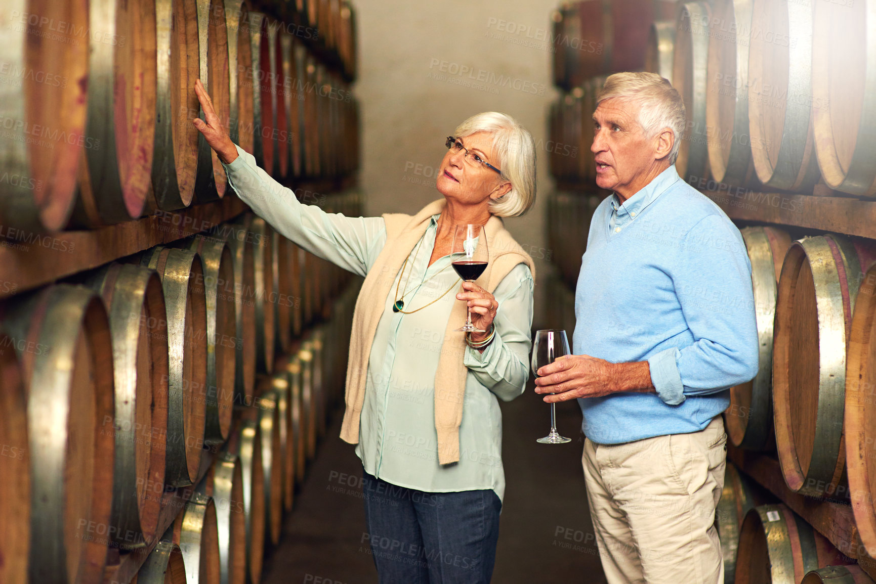 Buy stock photo Cropped shot of a senior couple enjoying a little wine tasting