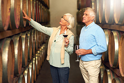 Buy stock photo Elderly couple, cellar and glass for wine tasting, retirement and france holiday together. Mature man, woman and romance with winery date, vacation and alcohol drink for anniversary and happiness