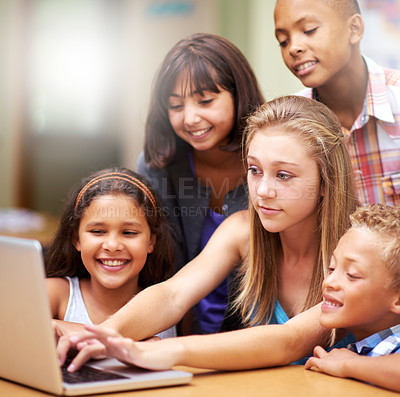 Buy stock photo Young tutor, laptop and teaching children. kids or pupils technology, social media or research in class. Group of elementary students with mentor showing tech, internet or online search in classroom