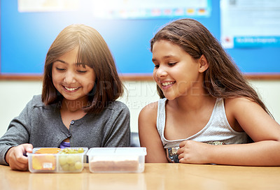 Buy stock photo Happy girls, students and lunchbox of food in classroom at school for meal, break or snack time together. Young little kids or elementary children smile with container for fruit and sandwich in class