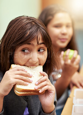 Buy stock photo Girl, face and student biting sandwich for meal, break or snack time in classroom at school. Hungry young kid or elementary child eating bread for food, fiber and nutrition in class during recess