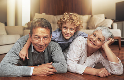 Buy stock photo Floor, smile and grandparents with grandson in living room, together and love with happiness. Old people, grandmother and grandpa in house as seniors in retirement, elderly and bonding with boy