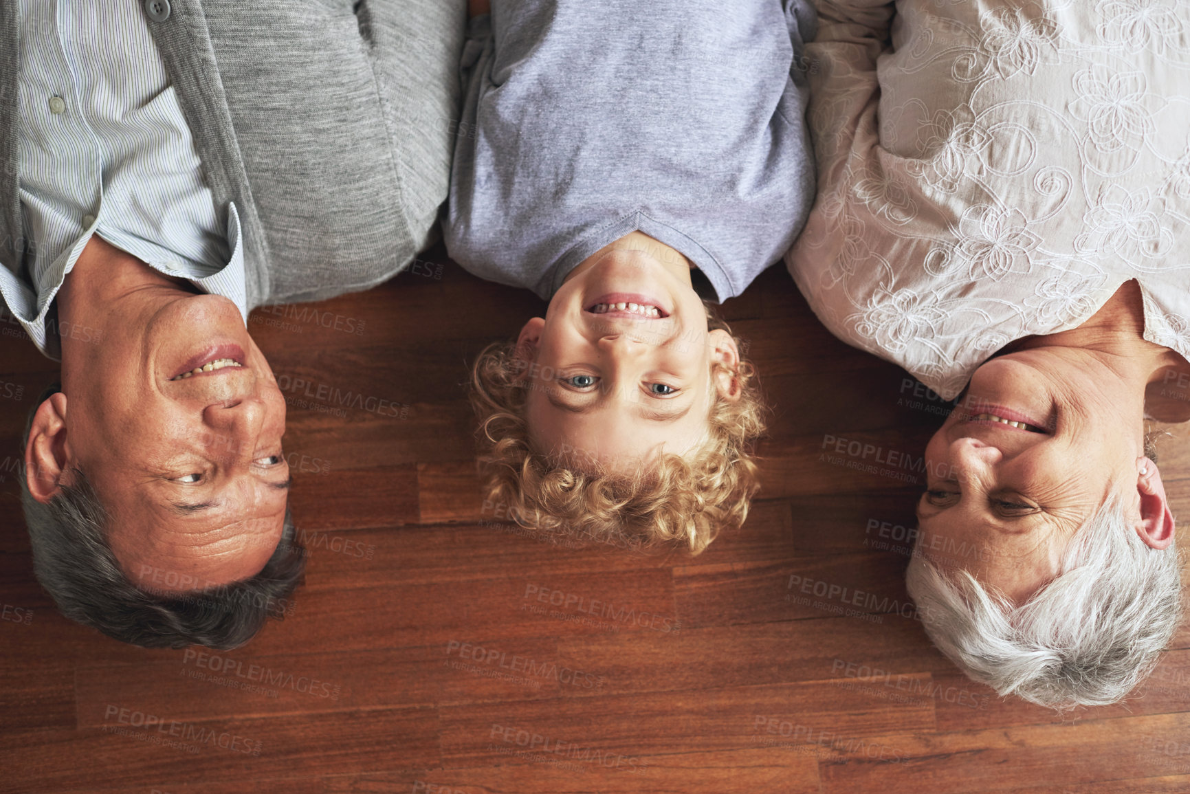 Buy stock photo Portrait, grandparents and boy on the wooden floor or bonding together with vacation or apartment. Family, face or elderly man with old woman, grandkid or child with fun or cheerful with home or love
